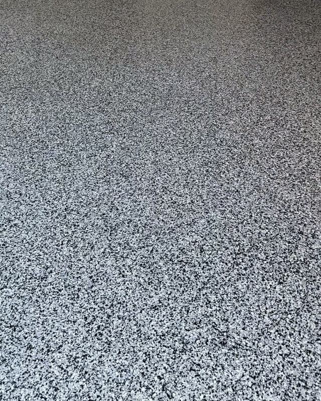 Finished grey, black and white flake garage floor