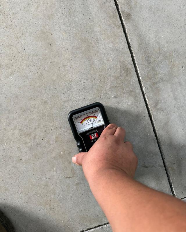 Moisture meter on a bare concrete slab